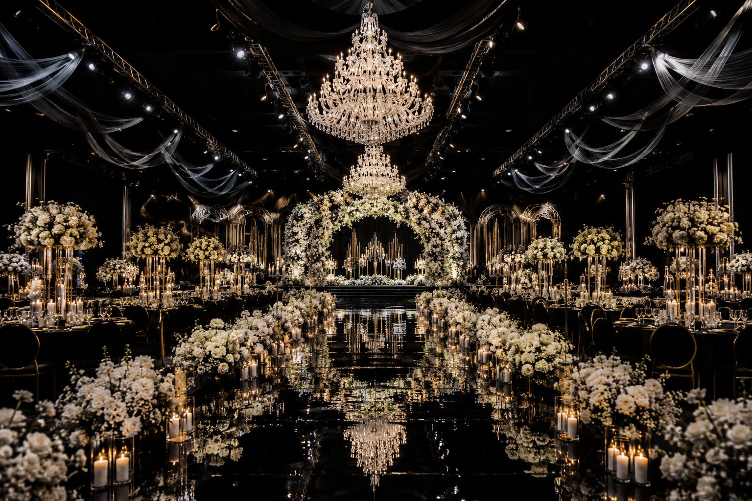 Luxury event hall with chandeliers and white floral arrangements